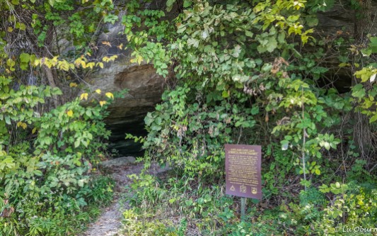 Signage identifying a cave used by Lewis & Clark, running along the Katy Trail.